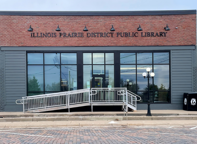 A building with a brick façade and large plate glass windows.