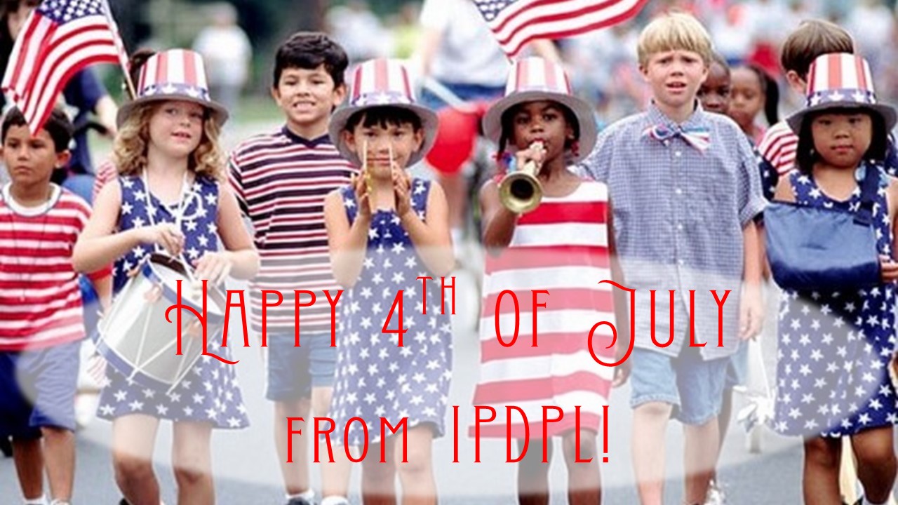 Children in patriotic outfits marching in a parade