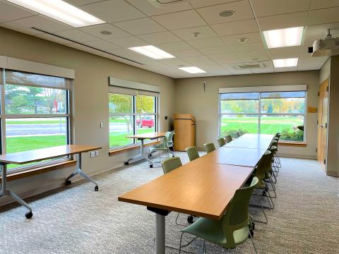 A large meeting room with tables and chairs.