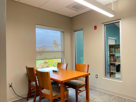 A room with a table and four chairs.