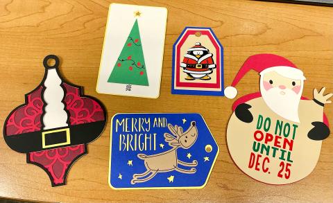 An assortment of five decorative tags for Christmas presents.