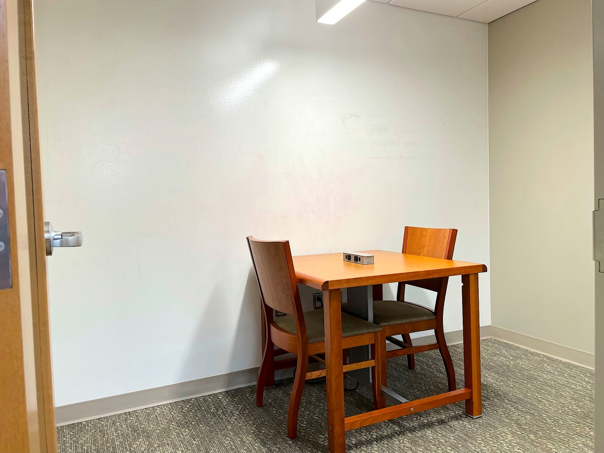 A small study area with a table and two chairs