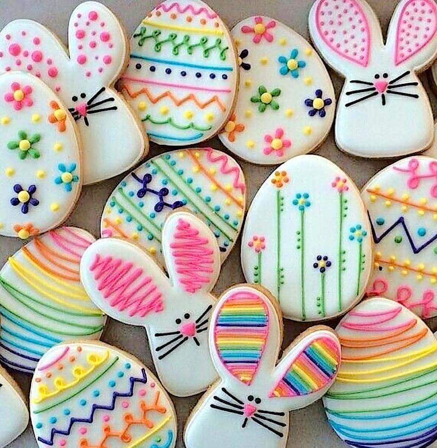 Assorted frosted sugar cookies in egg and rabbit shapes, decorated for Easter.  